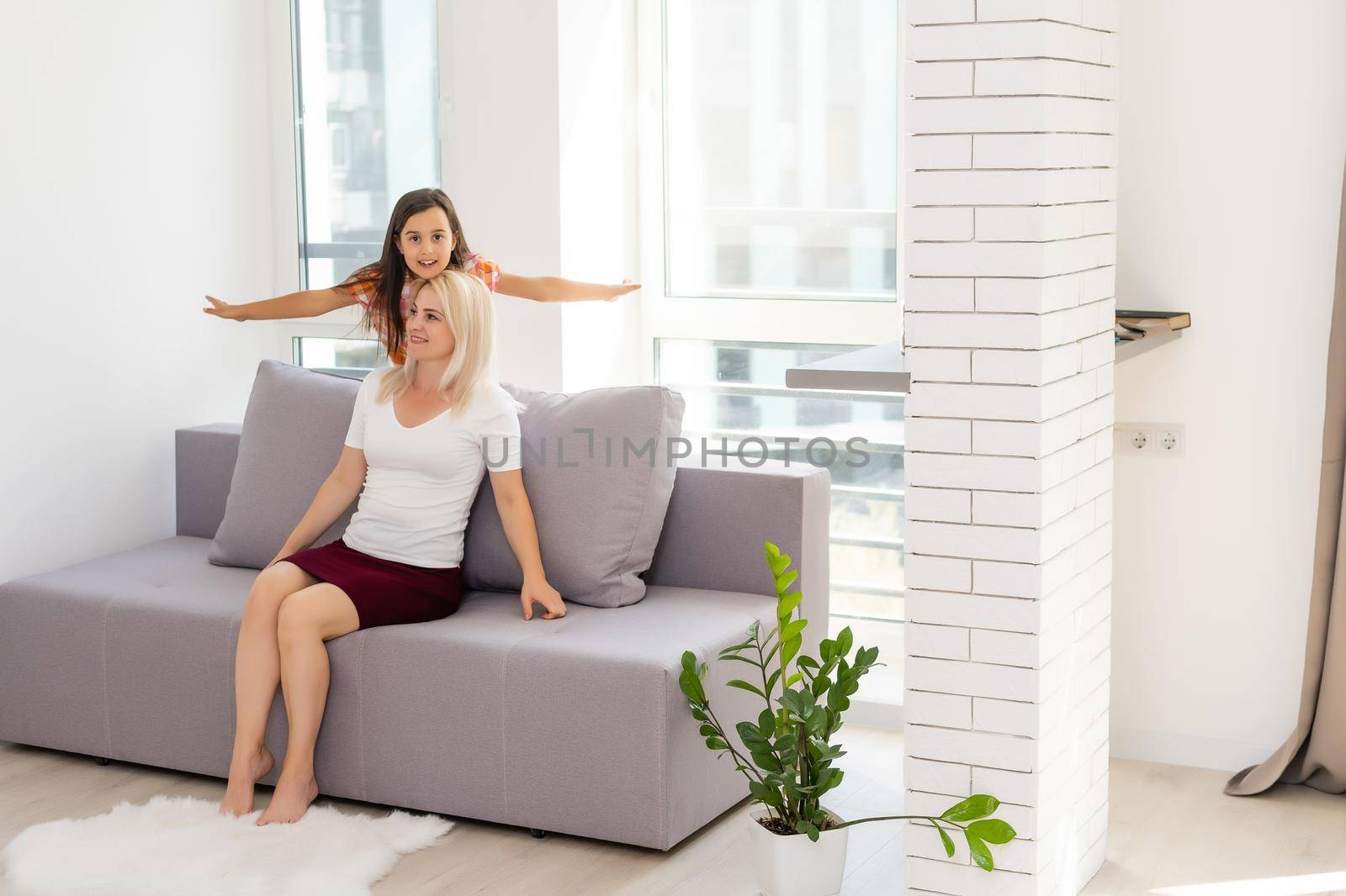 Happy loving family. mother and child girl playing, kissing and hugging