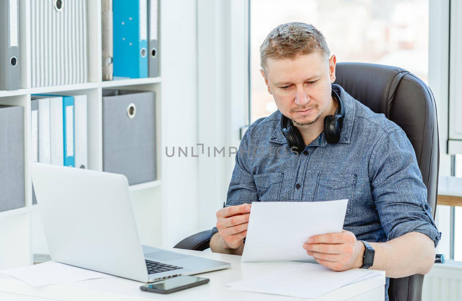Smiling man working in light office