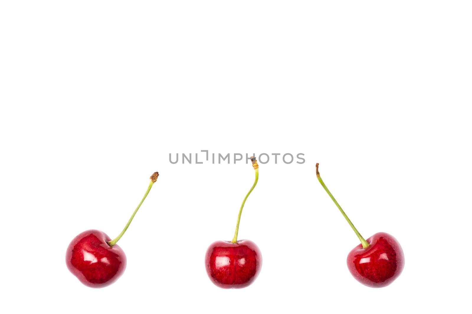 Ripe red sweet cherry isolated on white background. Macro photo close up. Three cherries on white background. Banner with copy space.