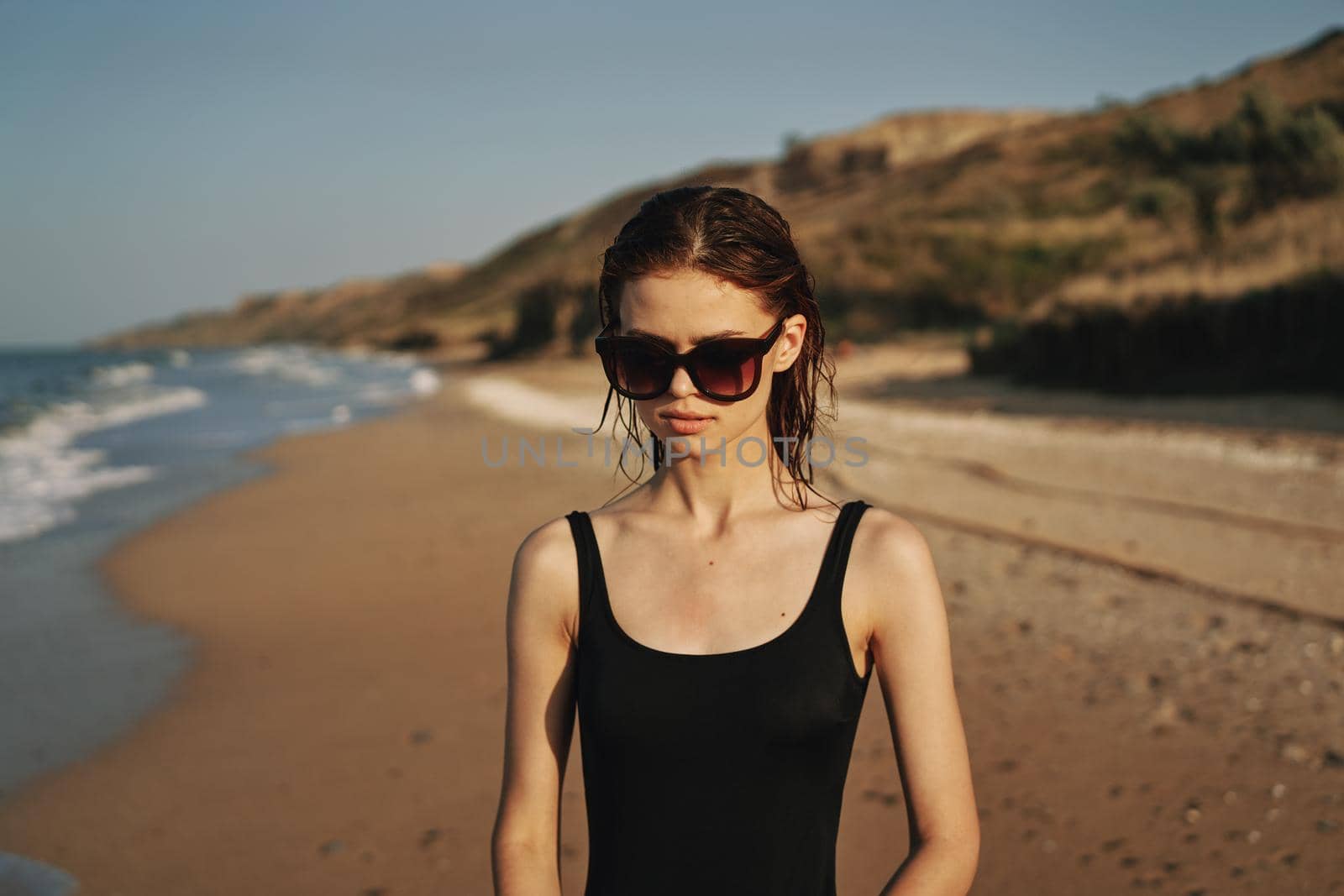 pretty woman in black swimsuit beach nature sun. High quality photo