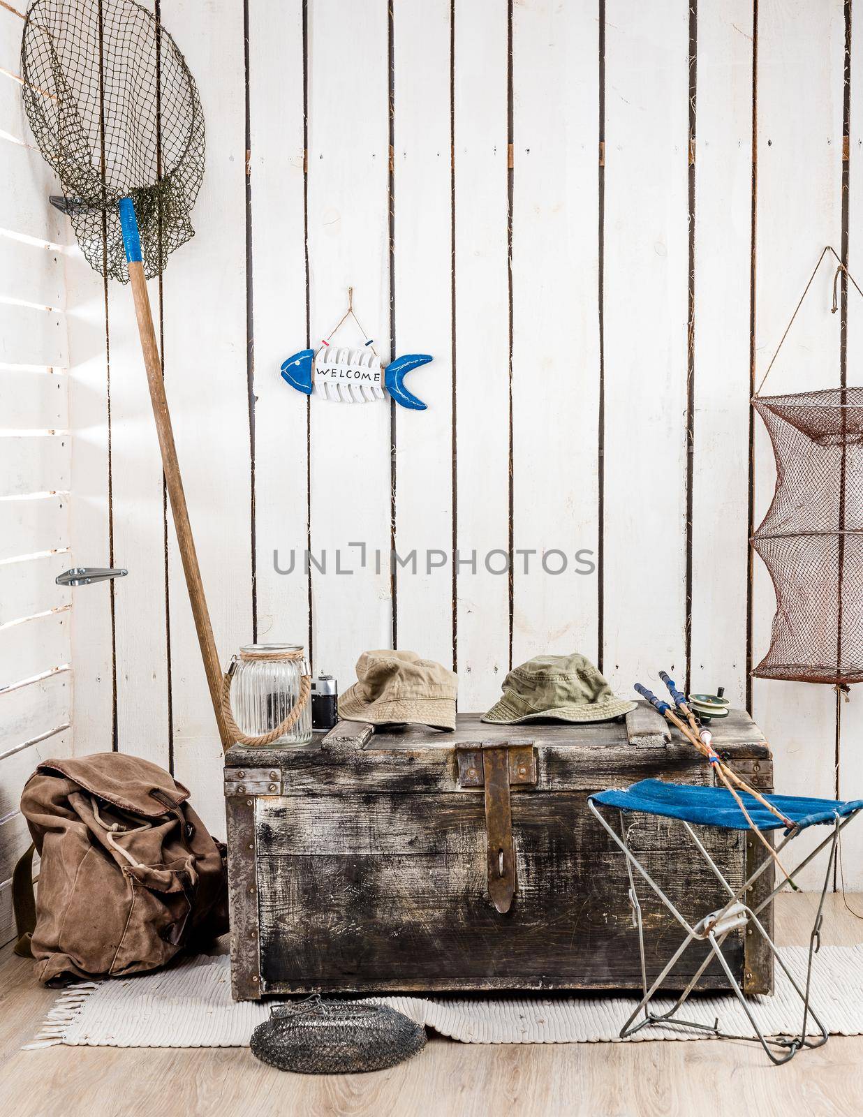 big old chest with things for fishing in decorated retro wooden room