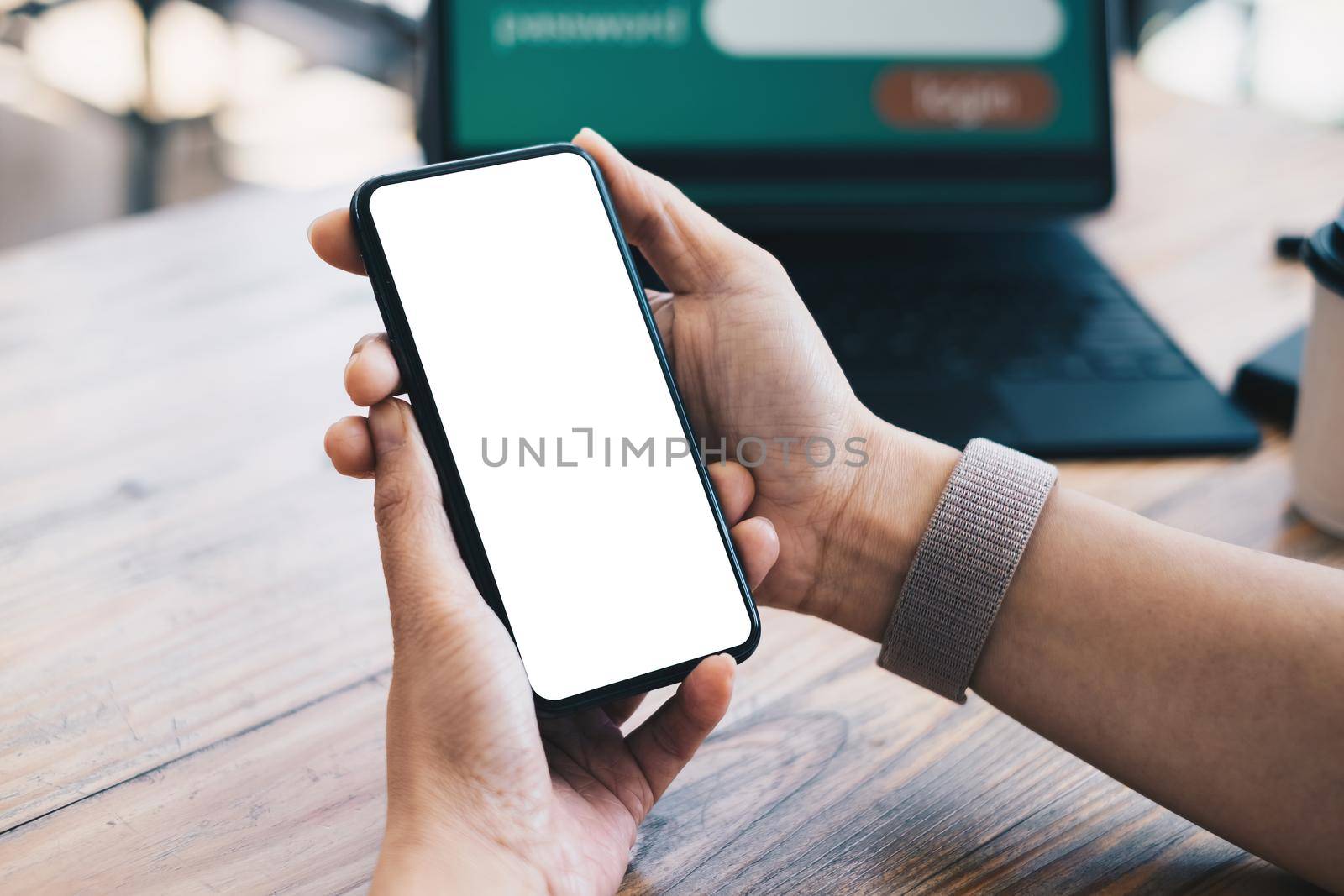 A woman hand holding smartphone device with blank screen. Blank screen for your advertising