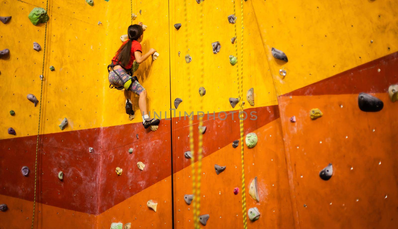 Little Girl Climbing Rock Wall