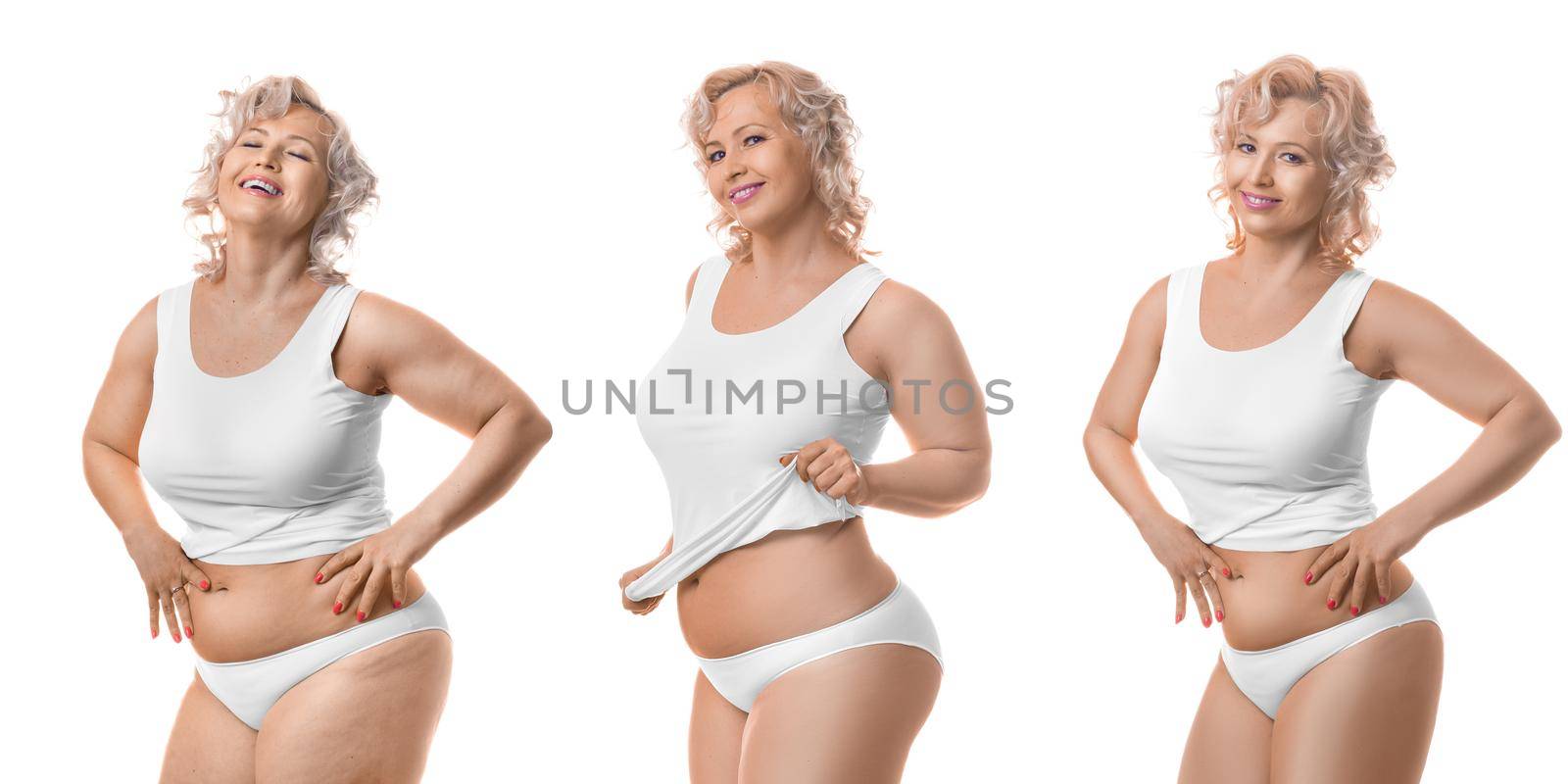 Process of slimming. Happy smiling middle aged plus size model in white lingerie. Isolated on white.