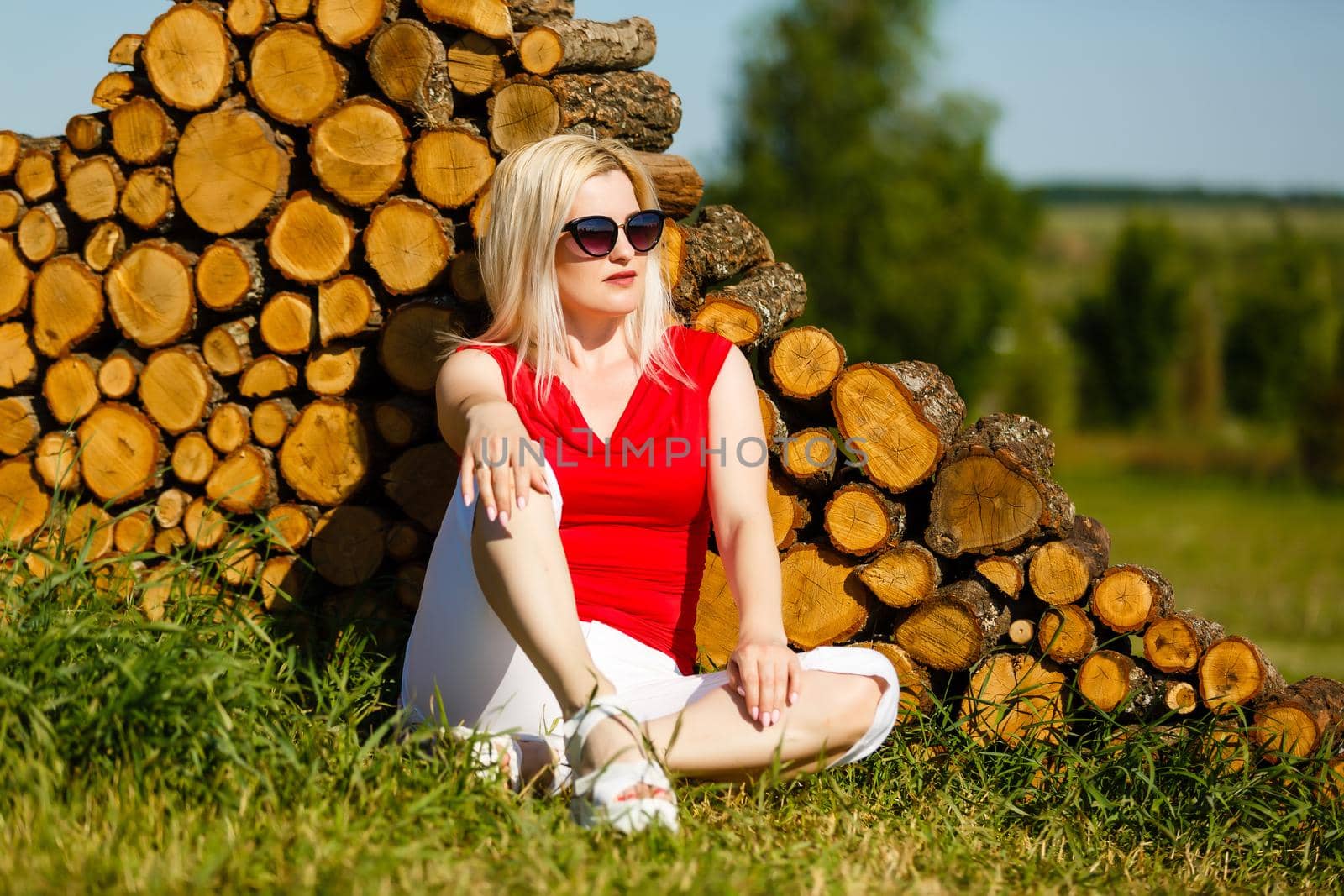Beautiful Young Woman Outdoors. Enjoy Nature. Healthy Smiling Girl in Green Grass.