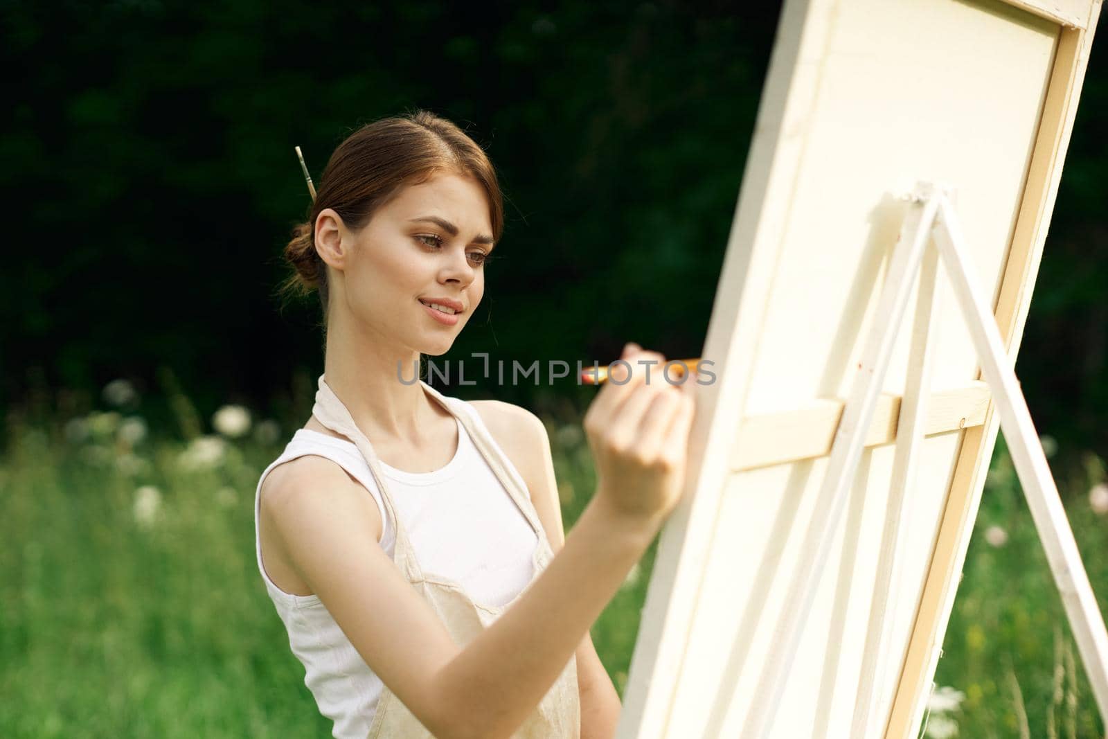 woman artist paints a picture near easel outdoors landscape creative by Vichizh