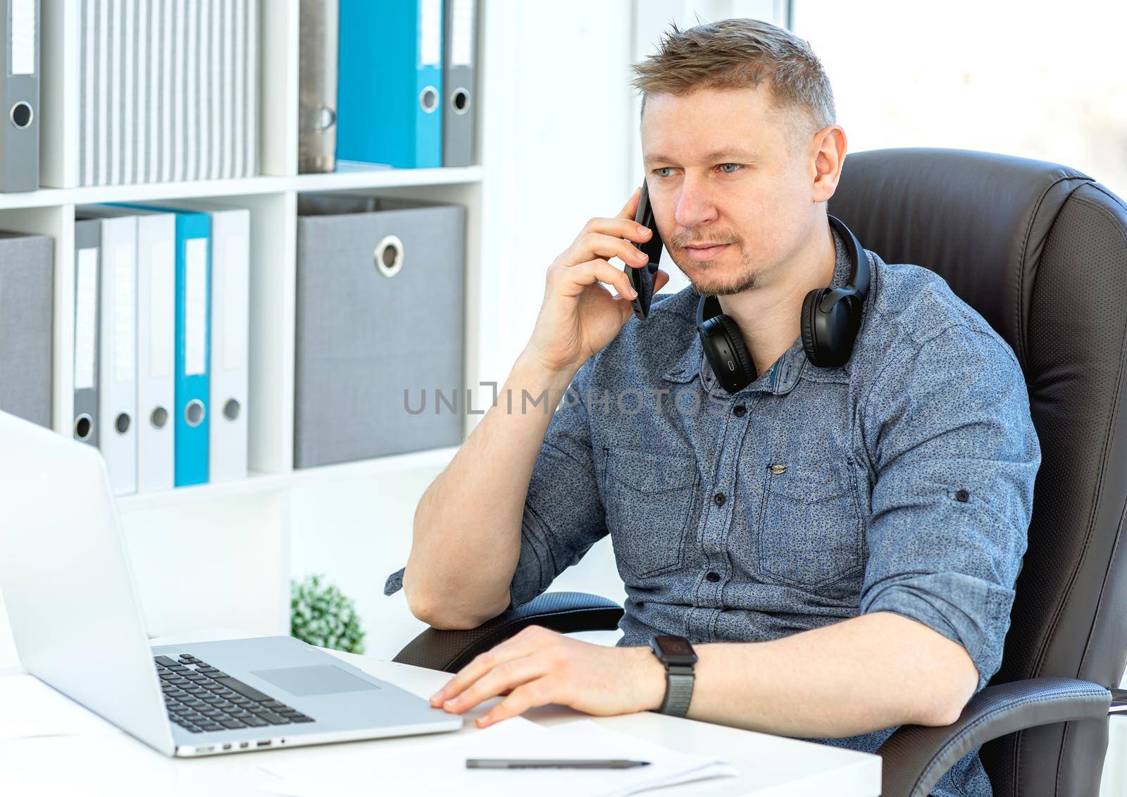 Smiling man working in light office