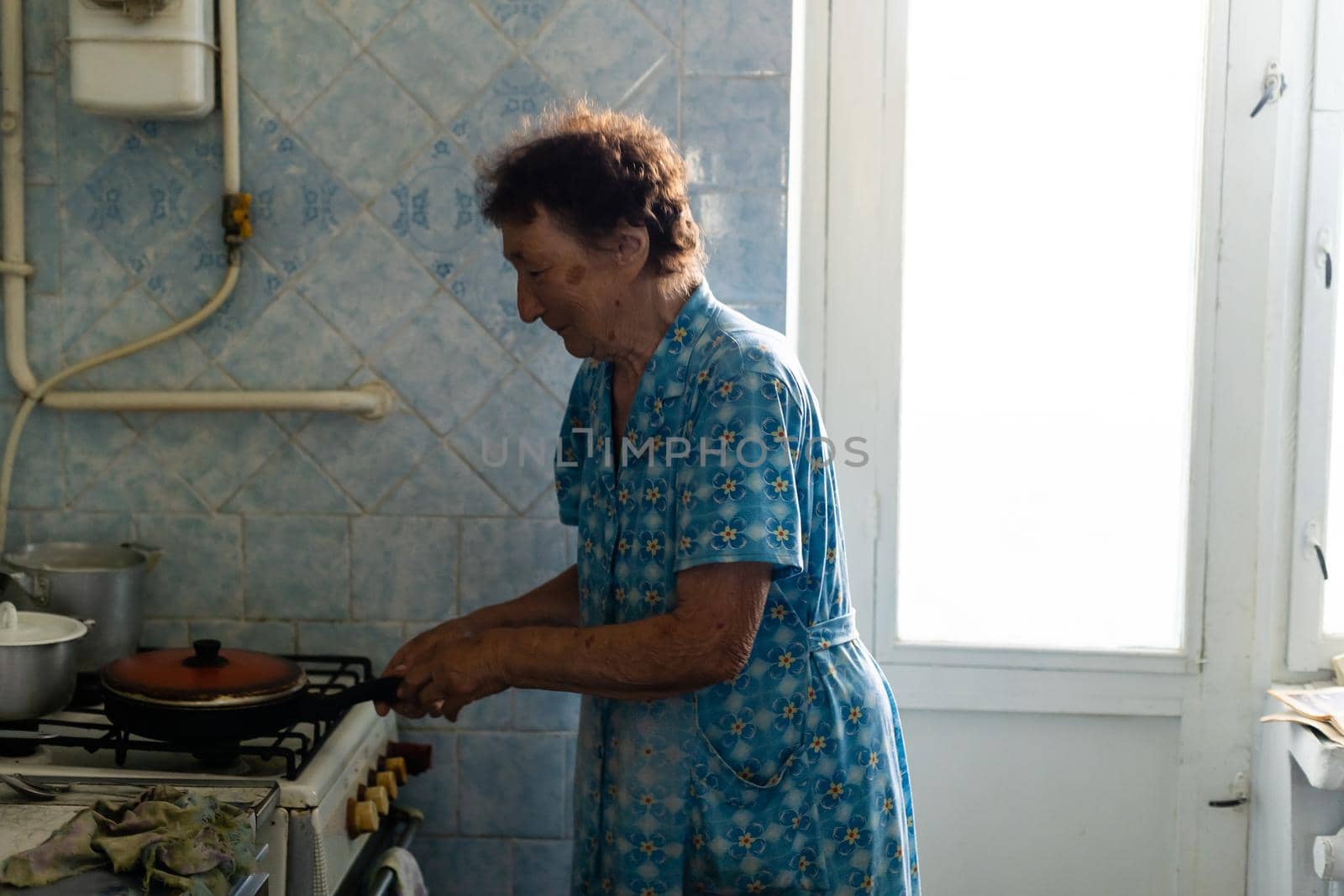 Happy senior woman cooking at home