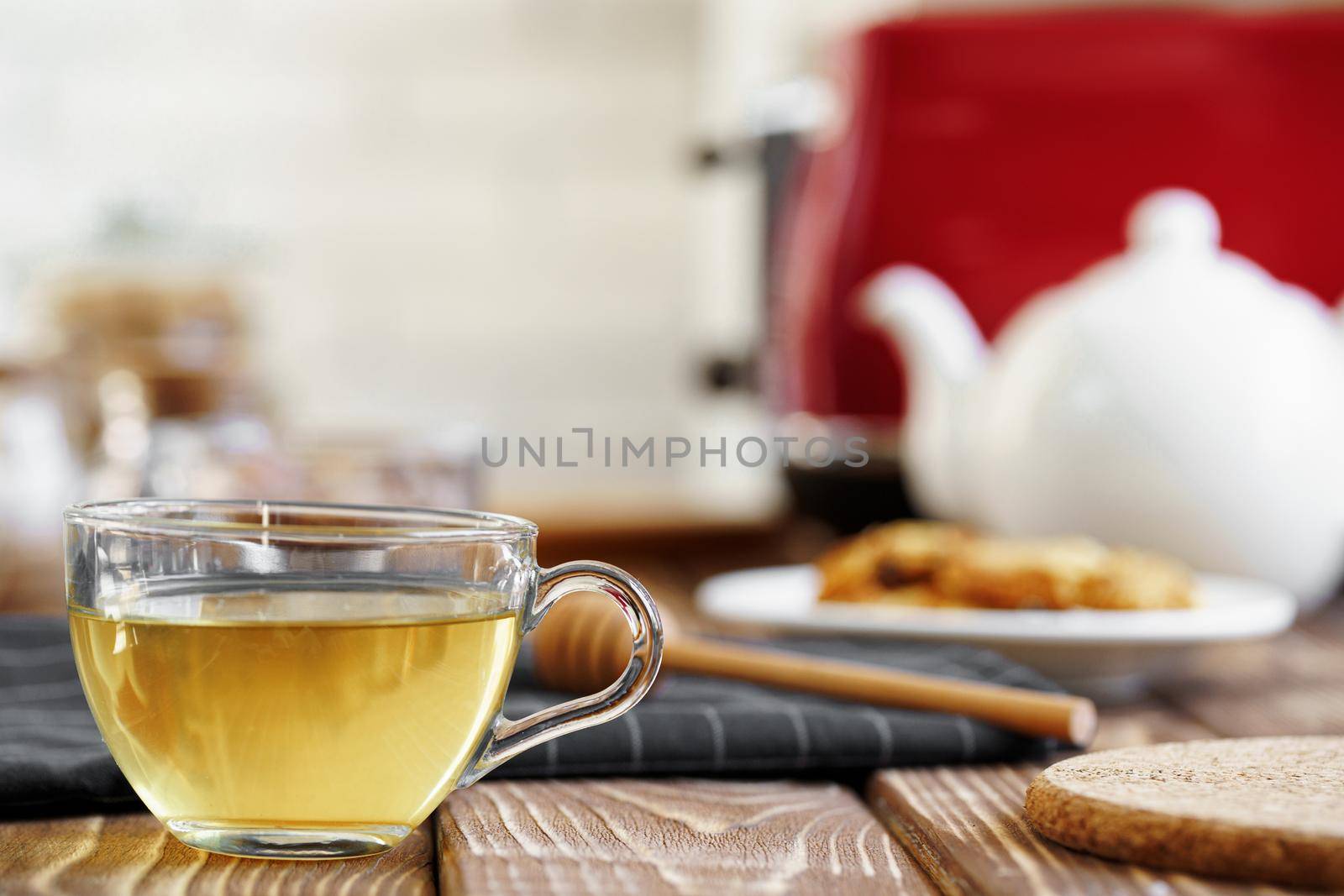 Ceramic teapot and toaster, kitchen table counter close up