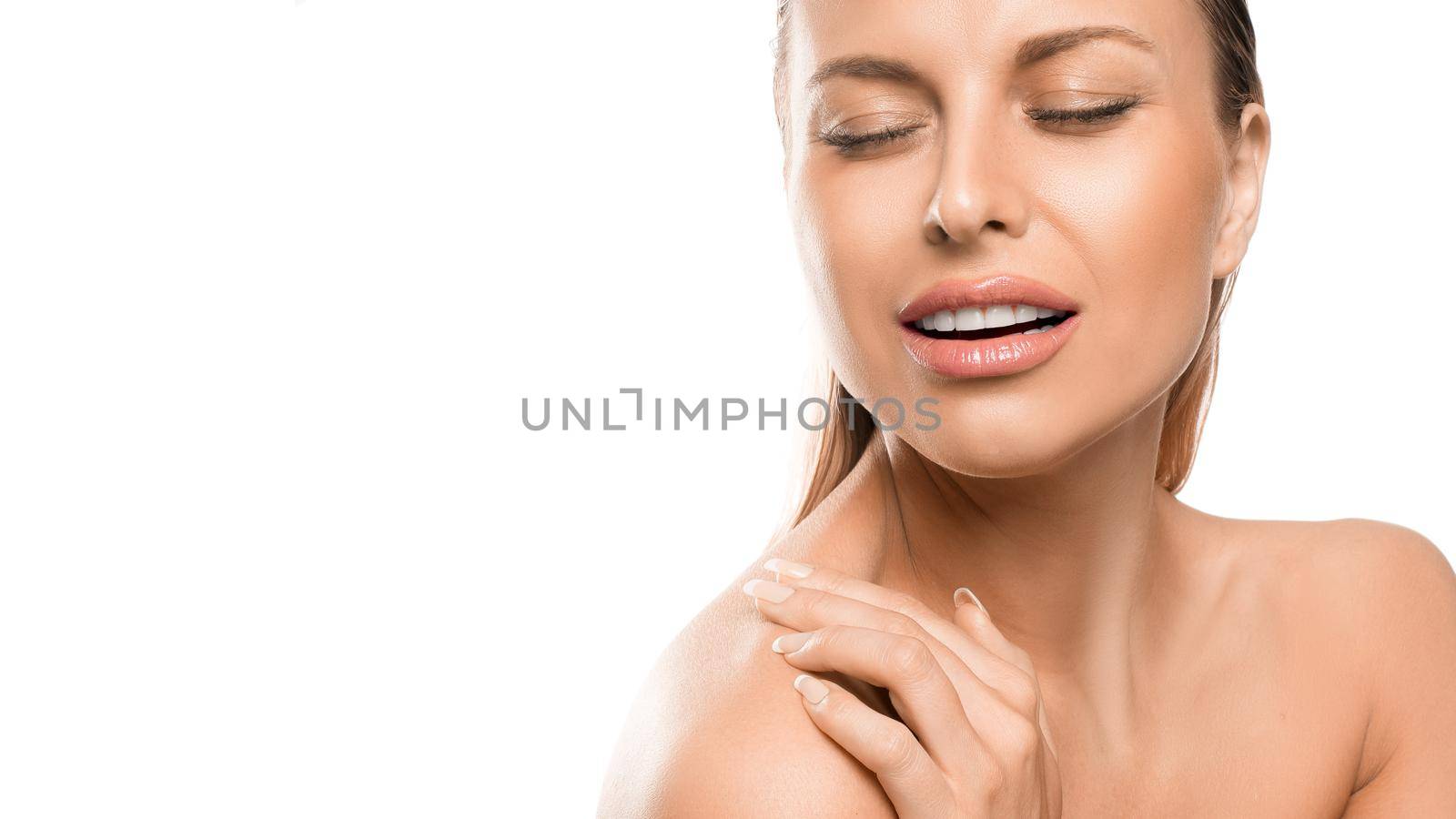 Close up portrait of a woman with closed eyes over white background. Pure sensuality and perfect shinig skin.