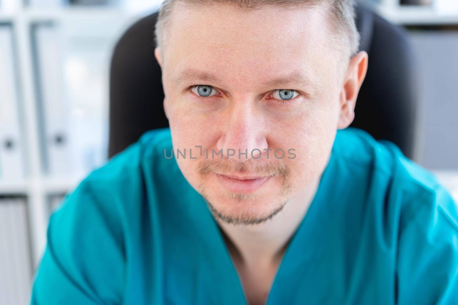 Portrait of attractive doctor in uniform at clinic