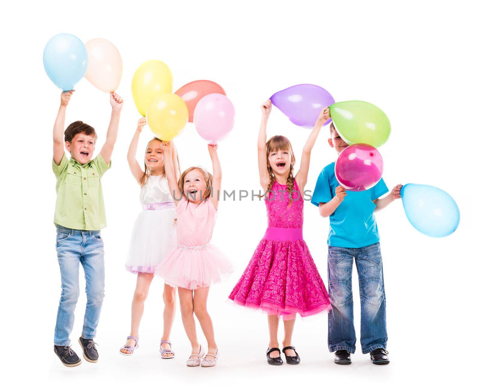 cute little children laughing with hands up and colorful baloons