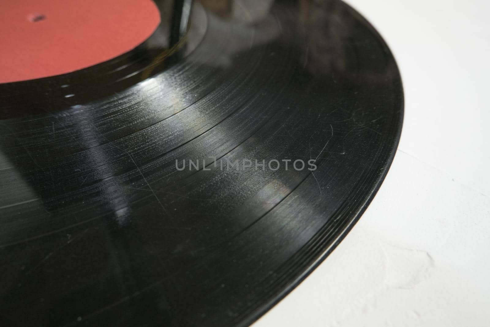 Old vinyl record in paper case on white marble background by Ekaterina34