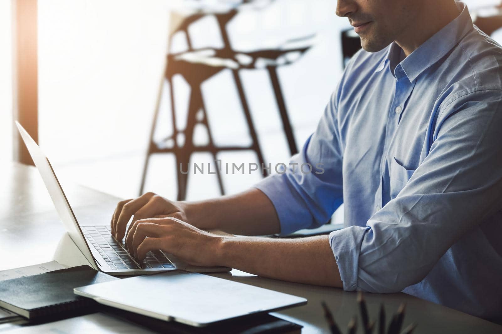 A male marketing manager using a computer to design a company's sales plan to present work to potential venture capitalists to maximize profits. by Manastrong