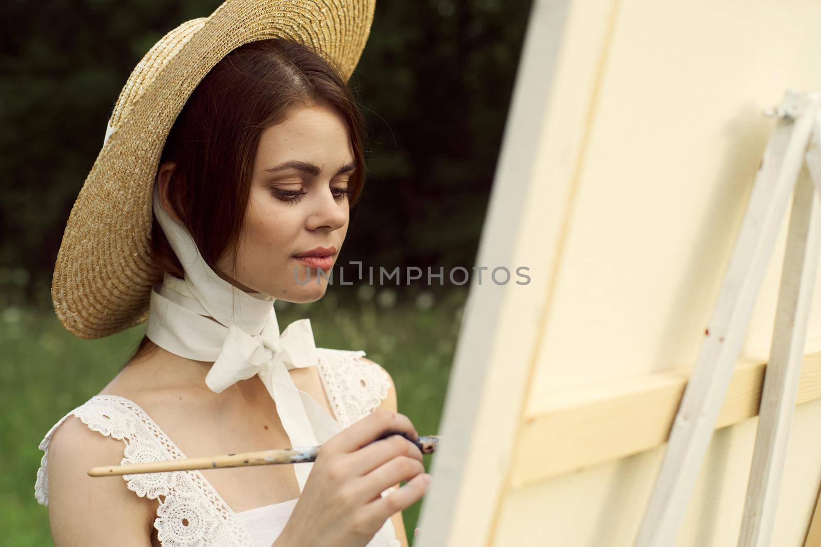 pretty woman artist painting nature painting art hobby. High quality photo