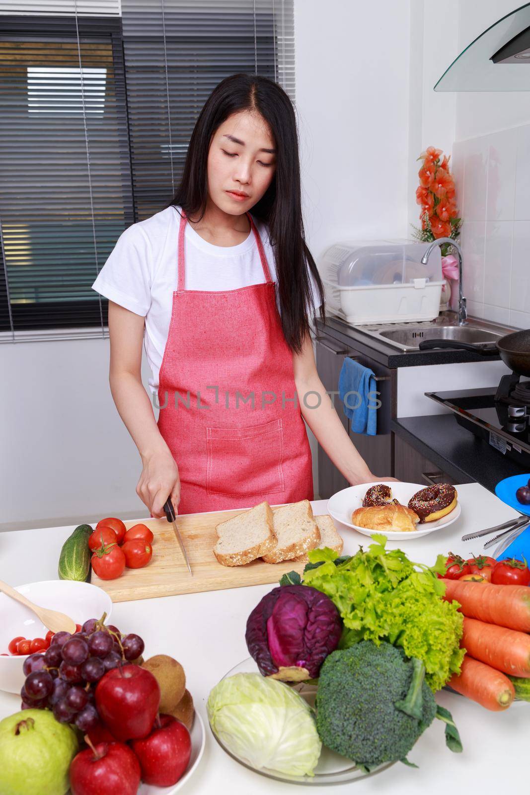 woman holding a knife in kitchen room at home