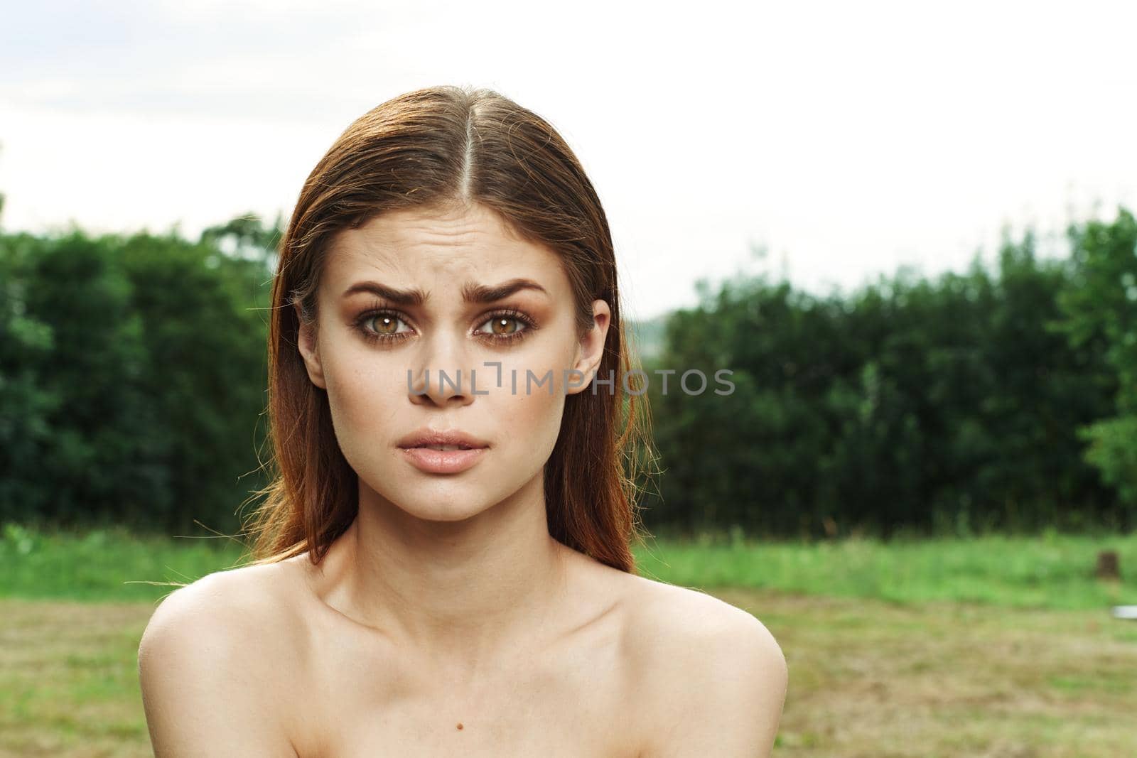 beautiful woman in a field outdoors bare shoulders clear skin model. High quality photo