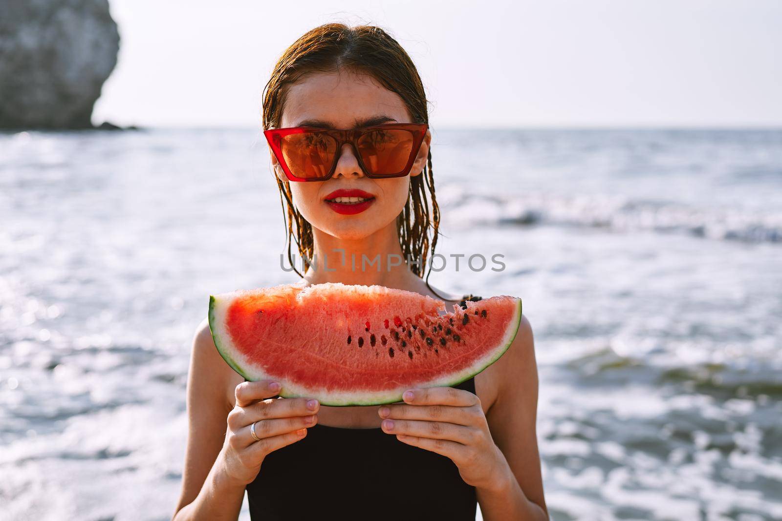 woman in swimsuit with watermelon outdoors sun fresh air. High quality photo