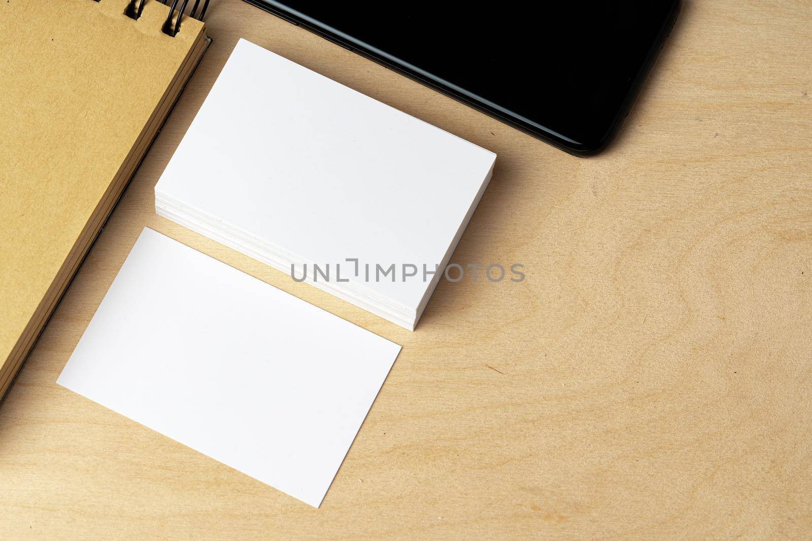 Two piles of blank business cards on table, close up