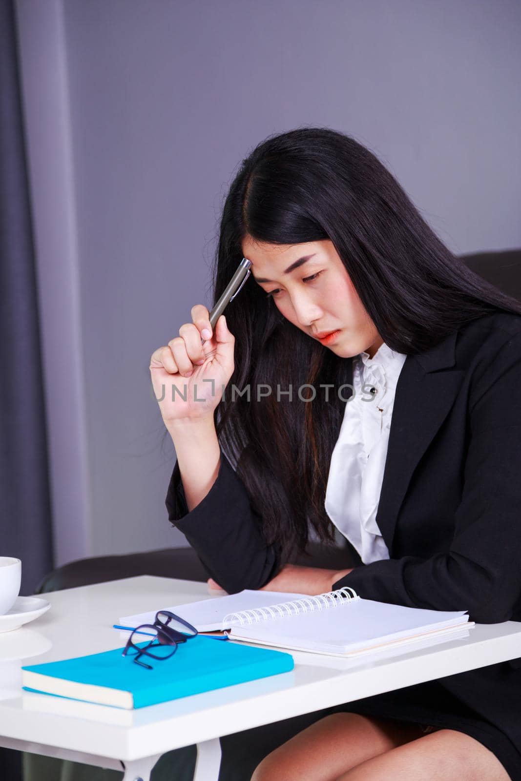 business woman sitting at the desk and thinking to her work by geargodz