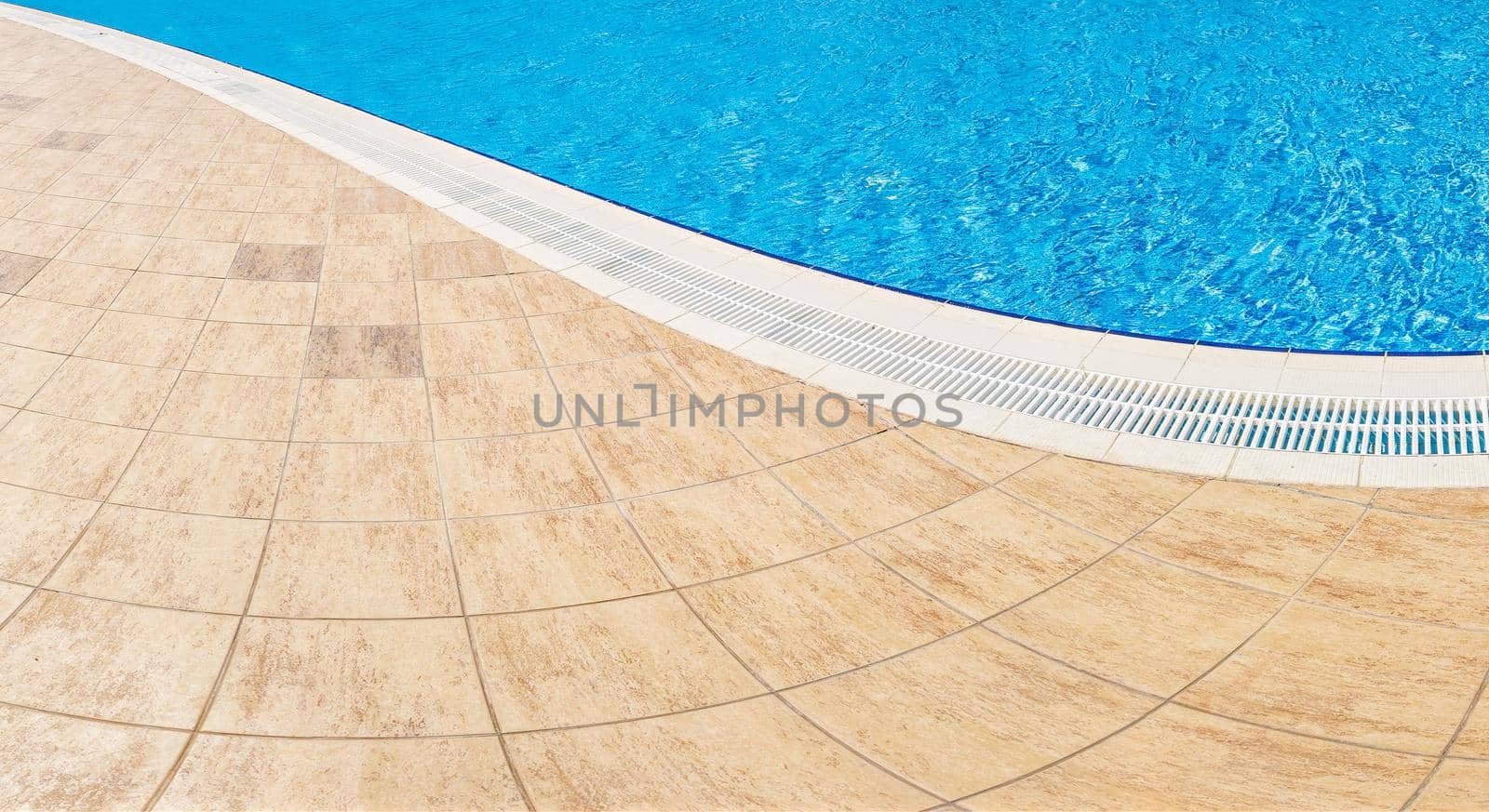 Abstract Pool with blue water background. Top view of swimming pool and floor texture. Panorama of pool bottom with tile pattern and transparent water. Summer travel and vacation background concept by panophotograph