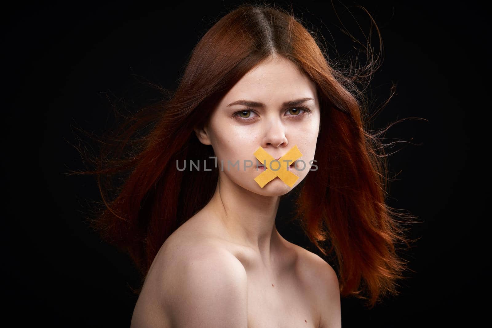 woman with bare shoulders taped mouth banned from diet. High quality photo