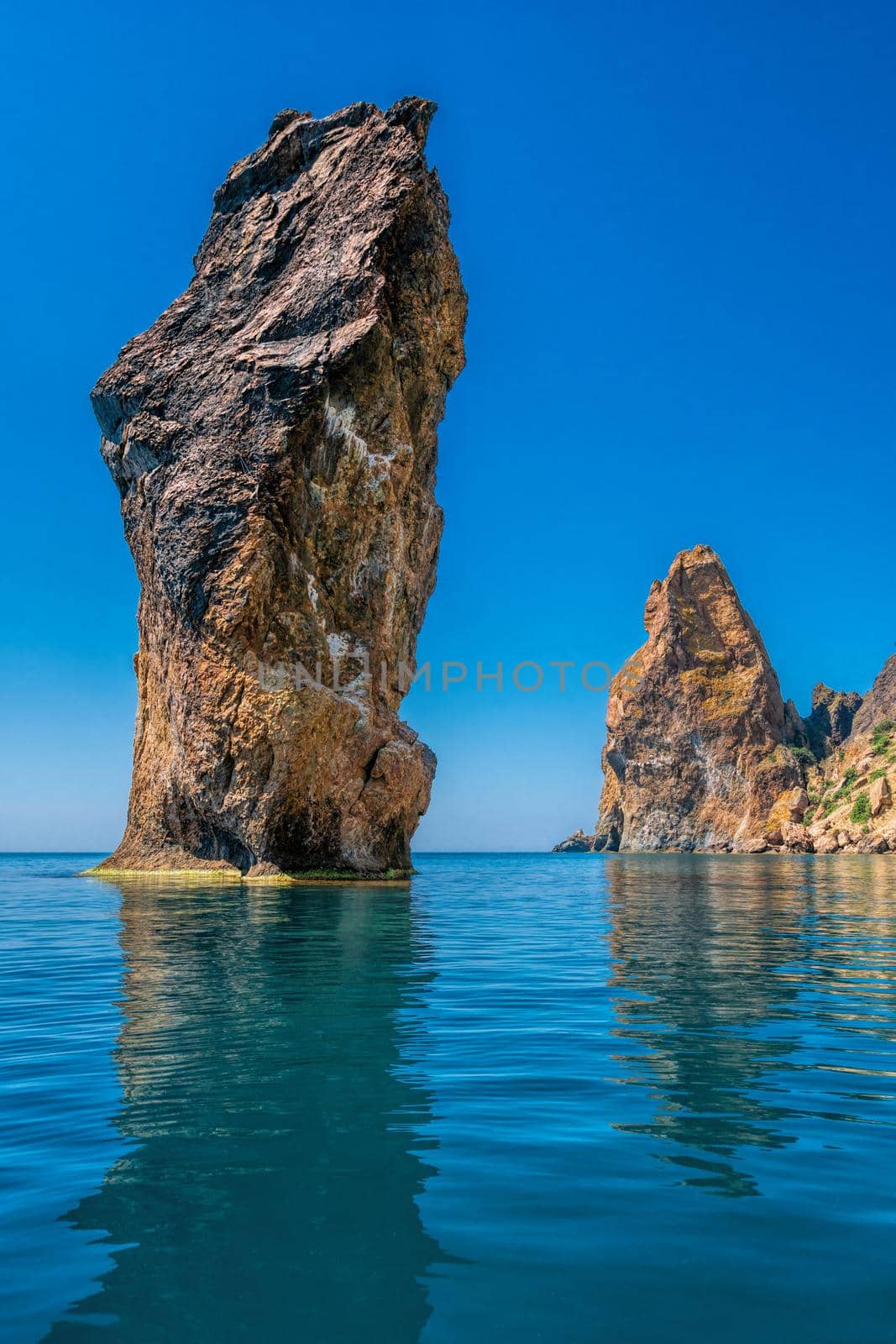 view on coastal cliffs, rock Orest and Pilad, cape Fiolent in Balaklava, Sevastopol Crimea. Bright sunny day, calm cristal clear blue sea. The concept of calmness silence and unity with nature