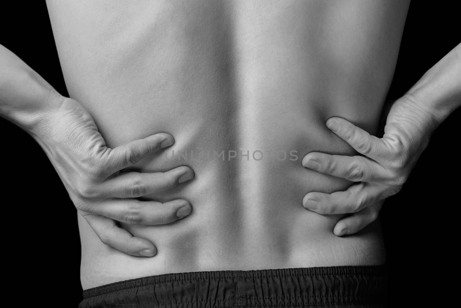 Acute pain in a male lower back, black and white image