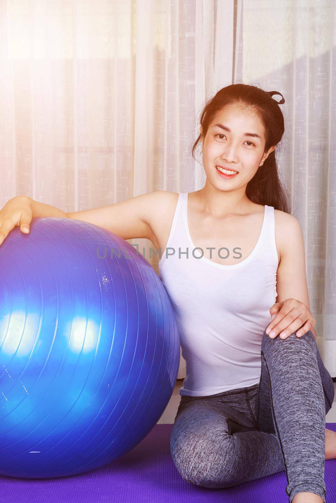 sport woman doing yoga exercise with fitness ball