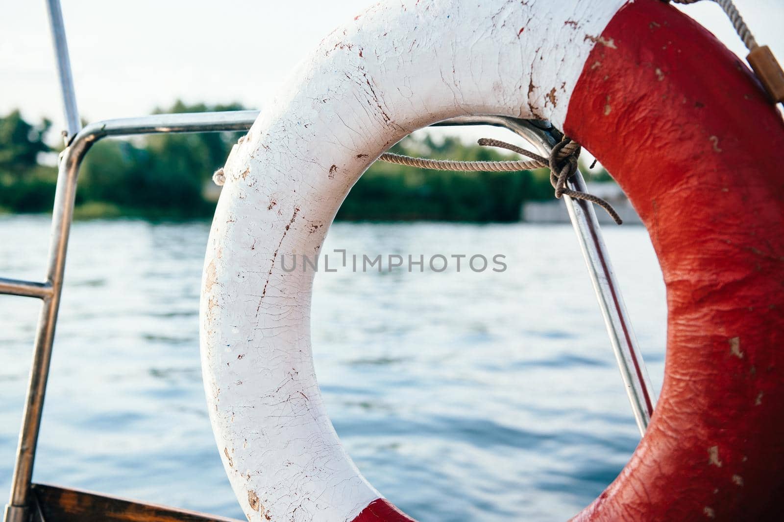 old lifebuoy in red and white on board the yacht