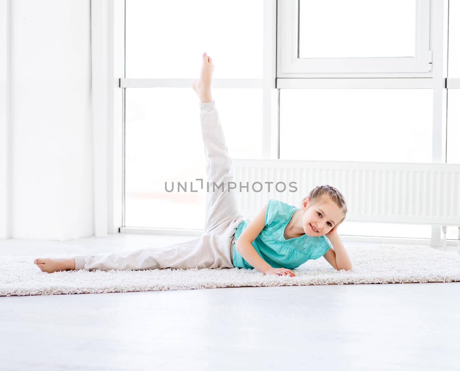 Cute little girl doing workout in gym
