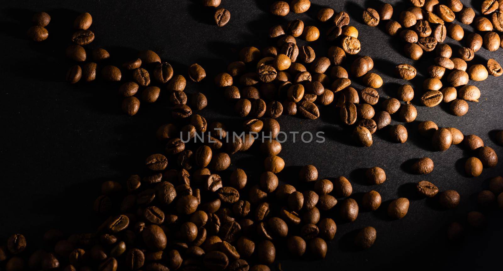 Flying coffee beans over dark.