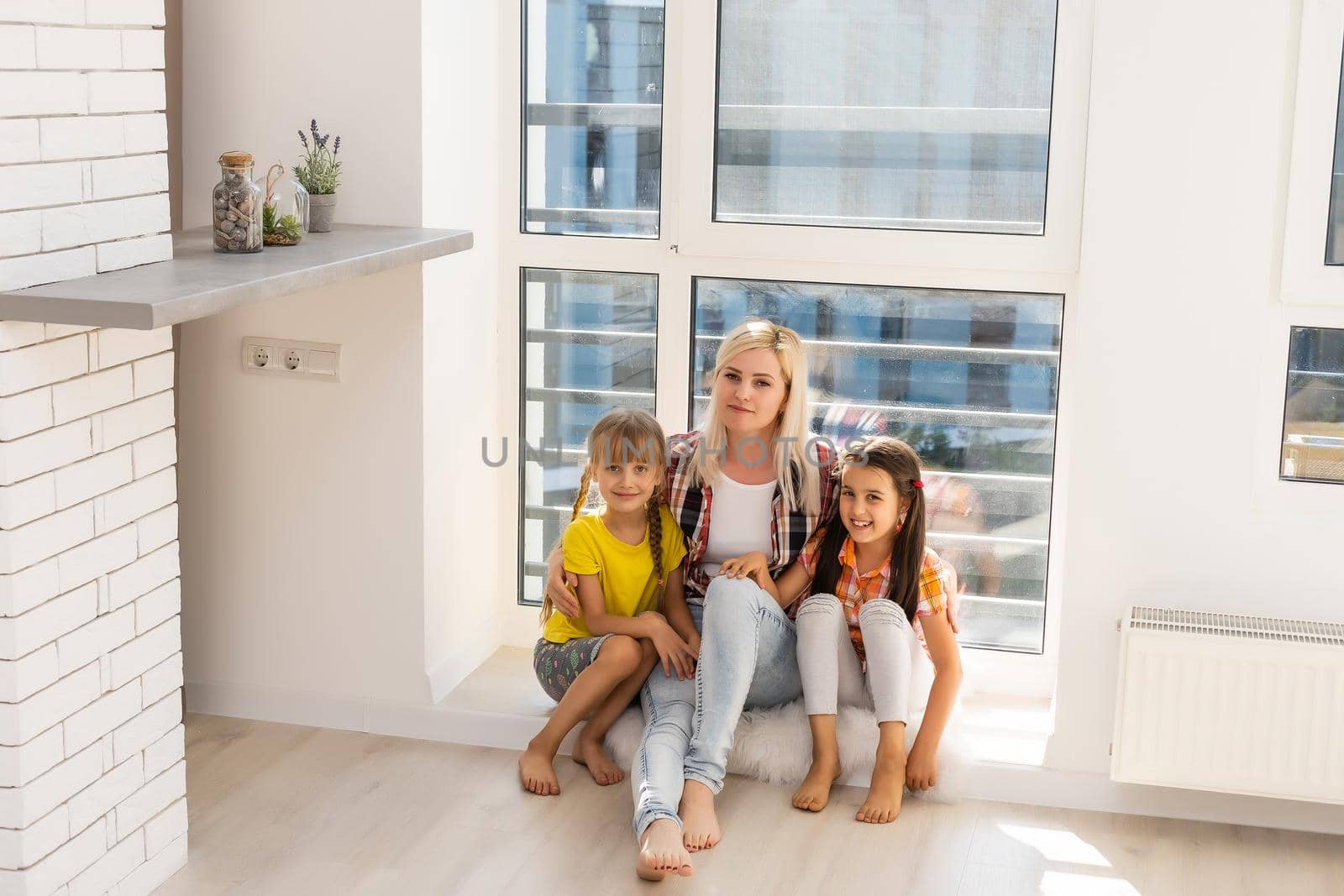 Woman and two young girls playing and smiling