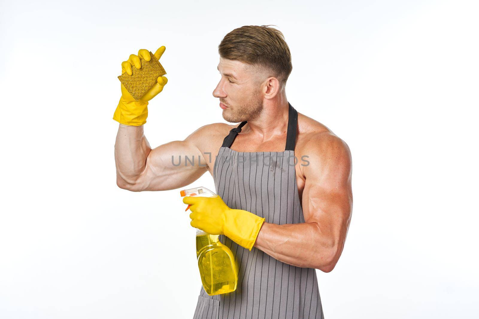 sporty muscular man with detergent cleaning posing. High quality photo