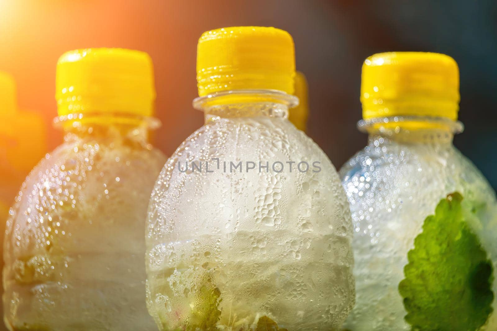 Selective focus on mojito or lemonade with mint. Summer time fresh cold drink. Lemonade or mojito cocktail with lemon and mint, cold refreshing drink or beverage with ice