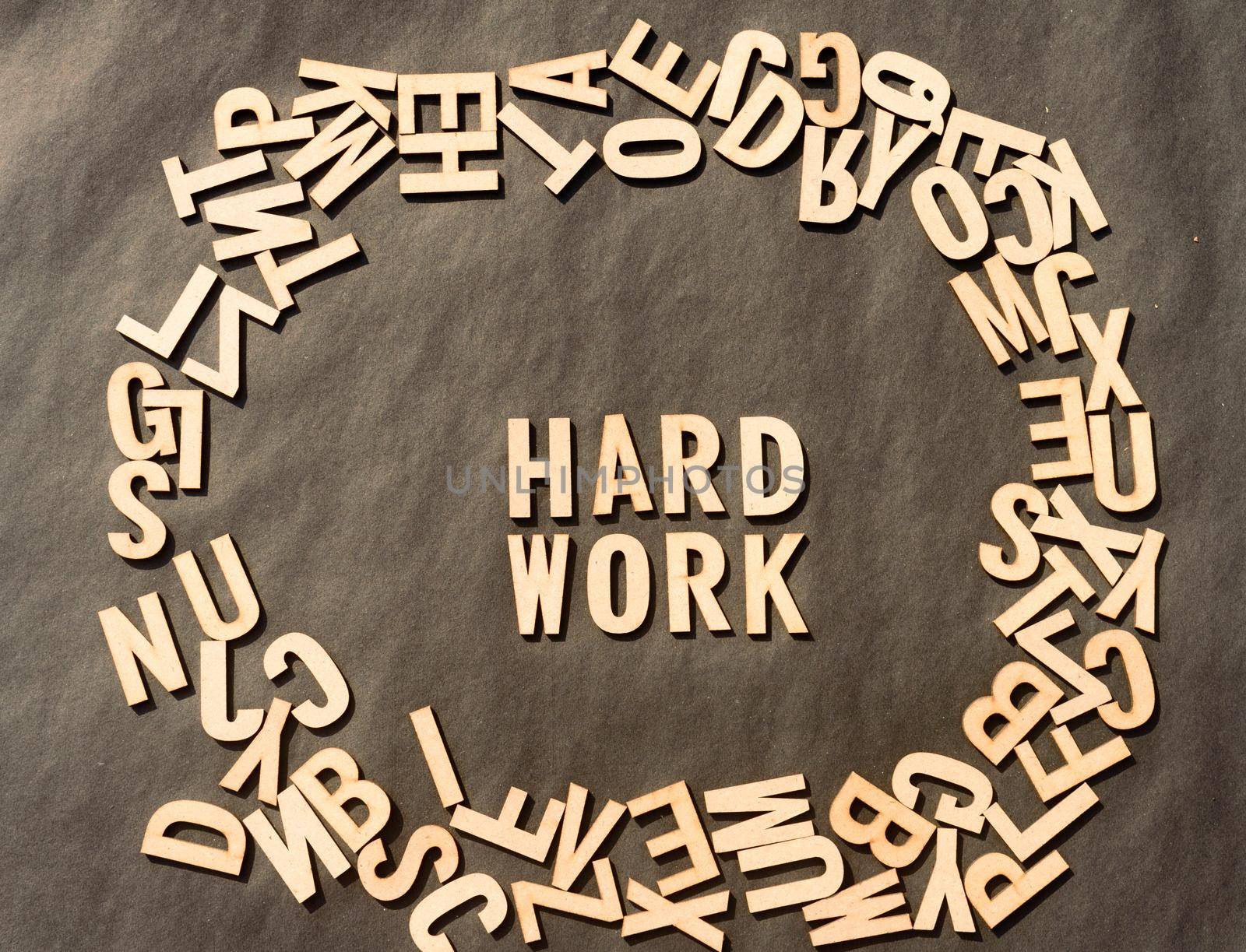 Work Hard Word In Wooden Cube Alphabet Letters Top View On A rustic paper Background. by sudiptabhowmick