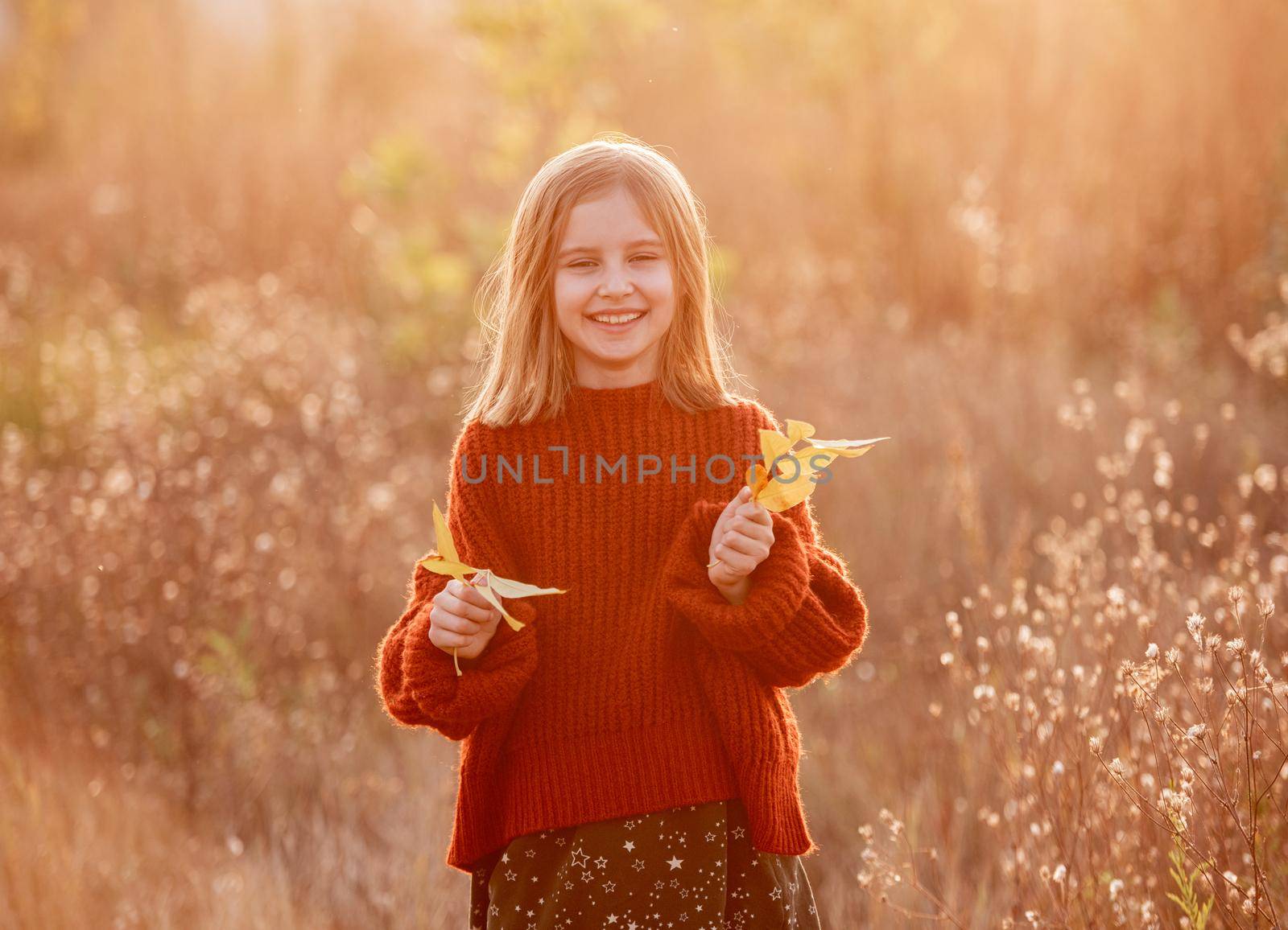 Smiling little girl with autumn leaves by tan4ikk1
