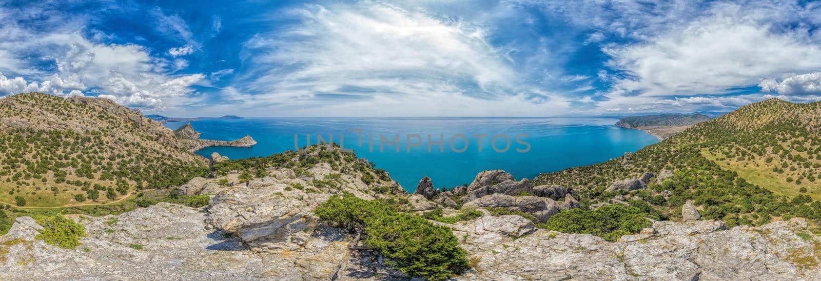 Beautiful seascape, panorama of cape Kapchik to the Galitsin Trail and blue bay of the Black Sea. Sudak, New World. Landscape of the sea coast. The concept of calmness, silence and unity with nature