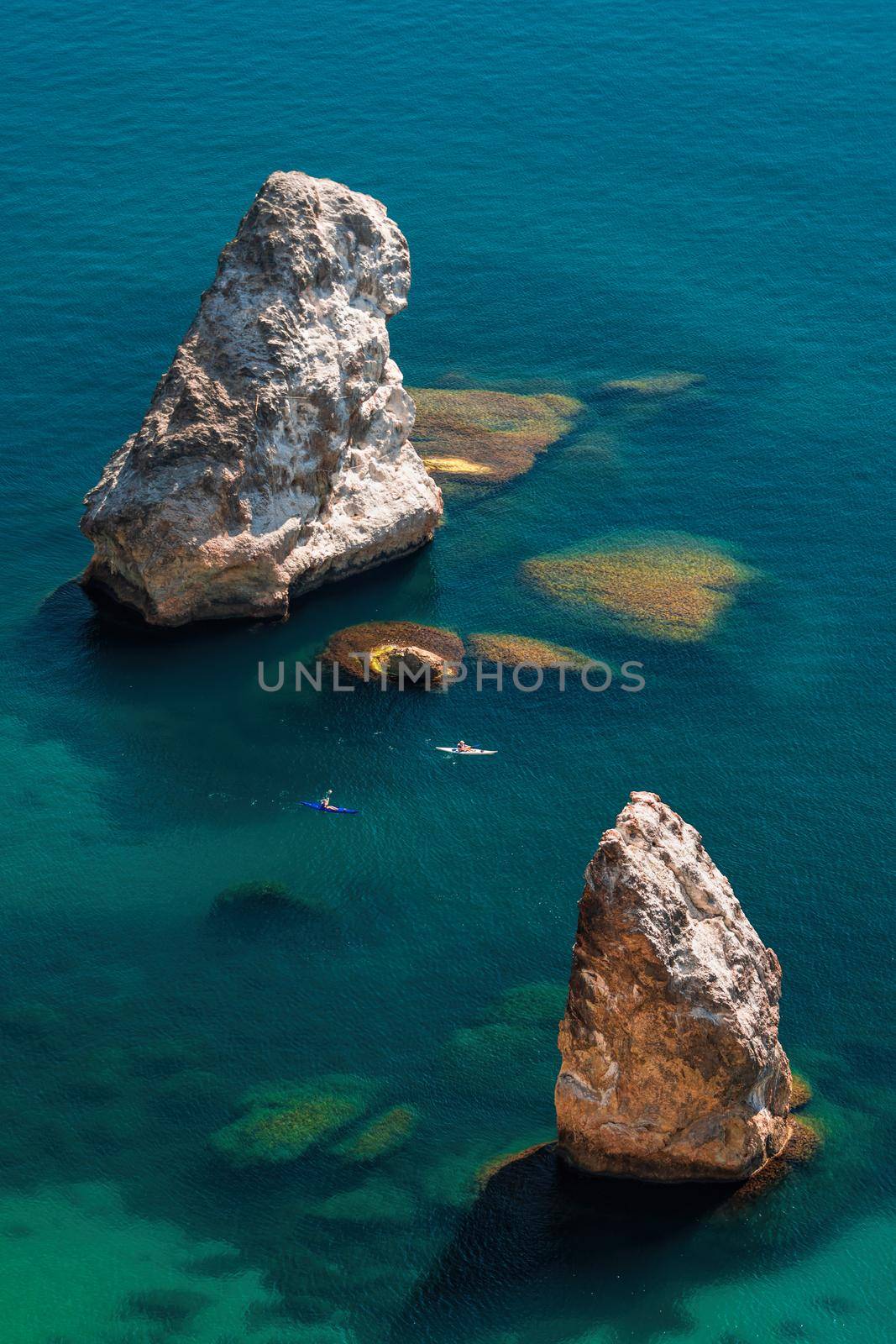 Two Kayaks on the background of coastal cliffs, calm clear blue sea, rock Orest and Pilad cape Fiolent in Balaklava Sevastopol Crimea. The concept of an active and healthy life in harmony with nature