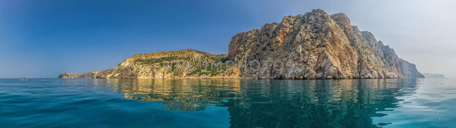 Yachts in the Sea on a background of rocky shores. Sea landscape with yachts and rocky coastline. Copy space. The concept of an summer holydays, relax, active and healthy life in harmony with nature. by panophotograph