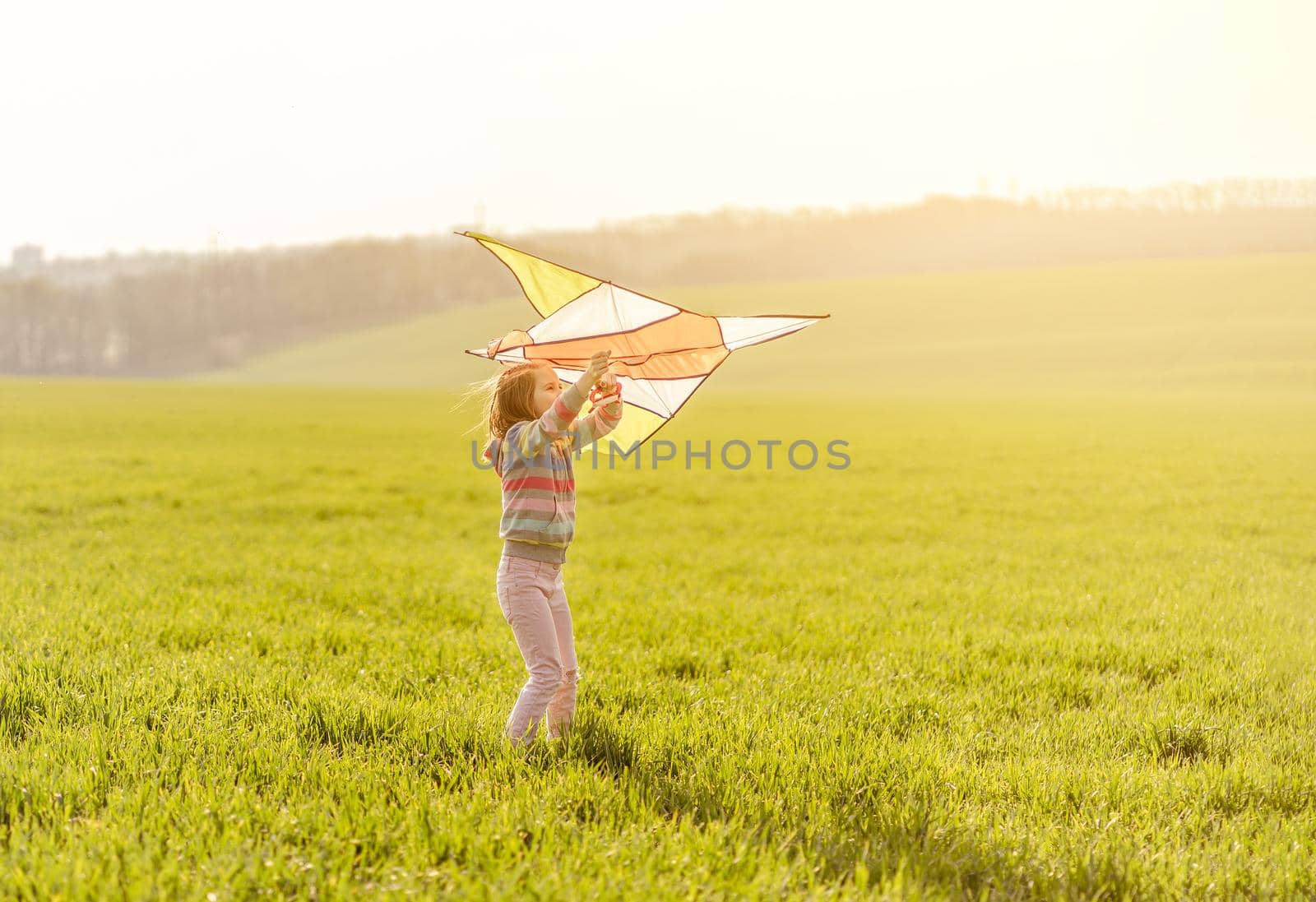 Little girl with flying kite by tan4ikk1