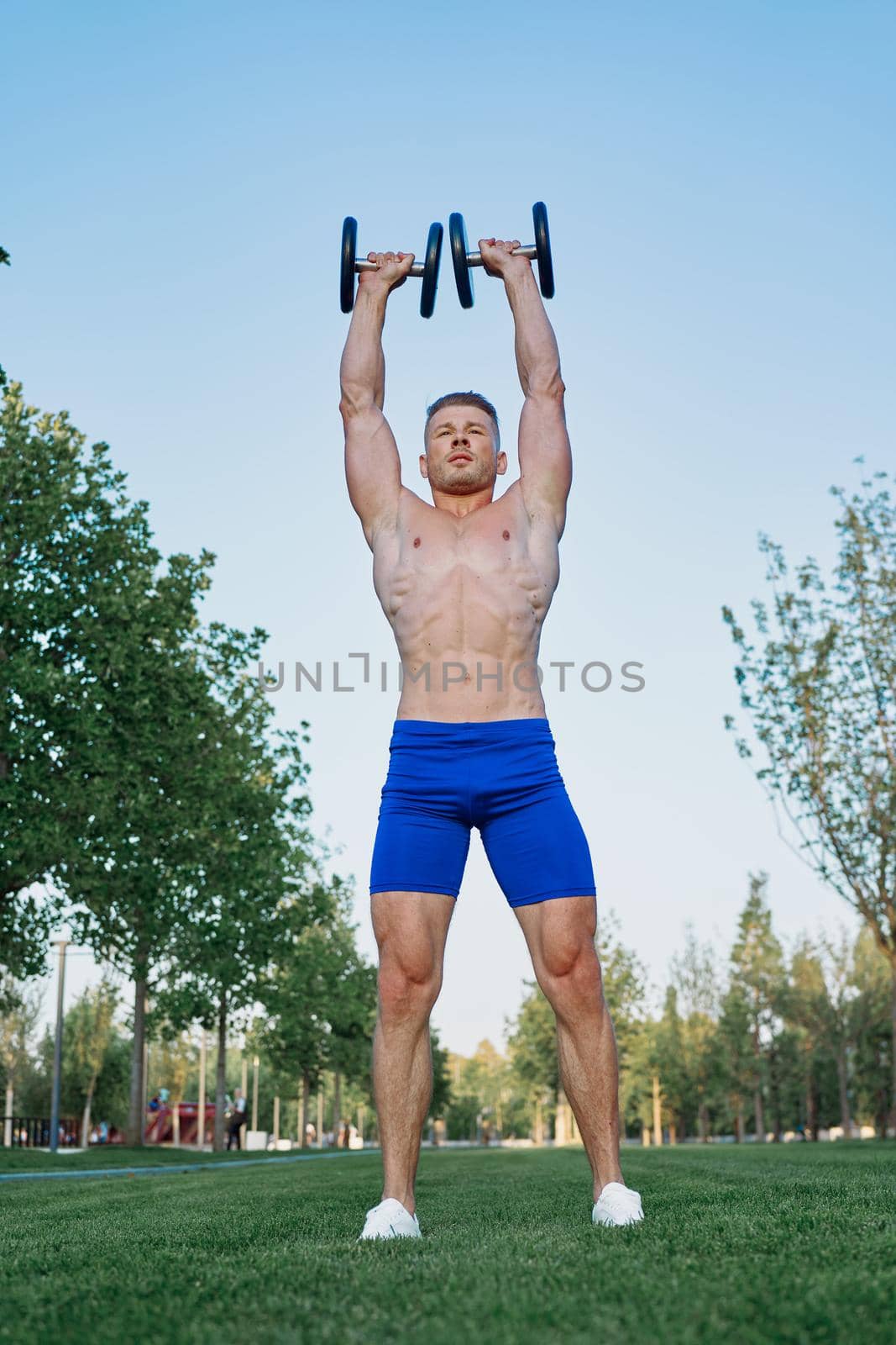 sporty man in park exercise crossfit workout. High quality photo