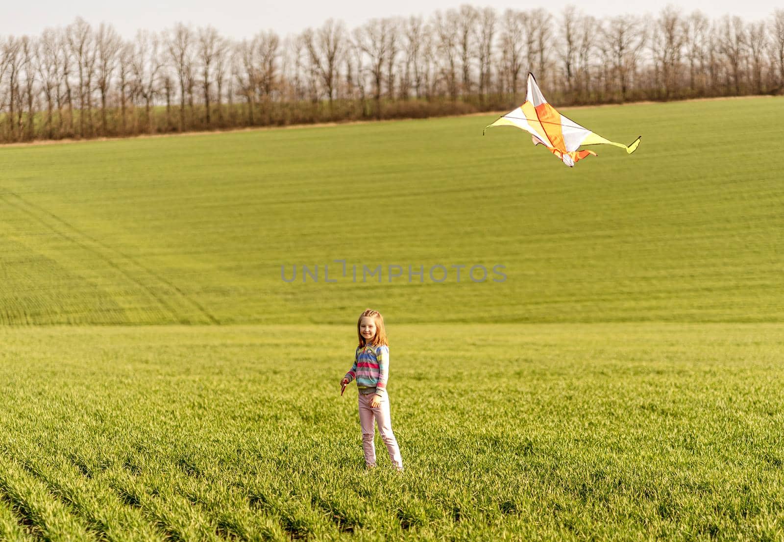 Little girl with flying kite by tan4ikk1