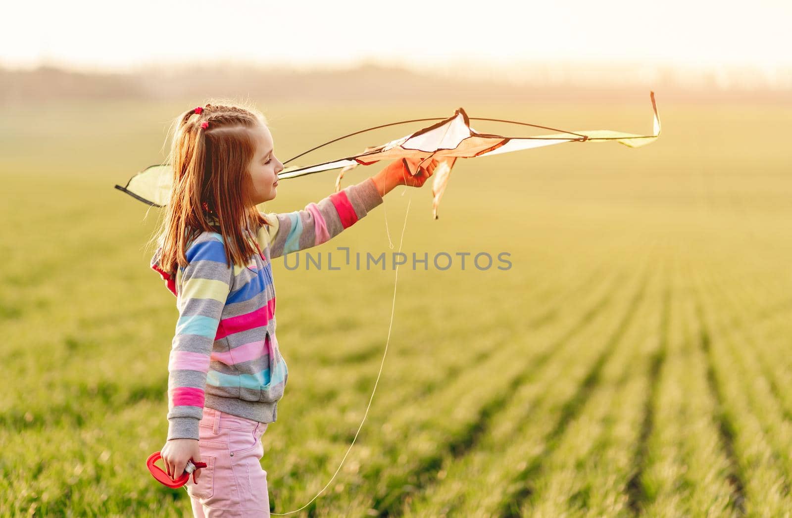 Little girl with flying kite by tan4ikk1