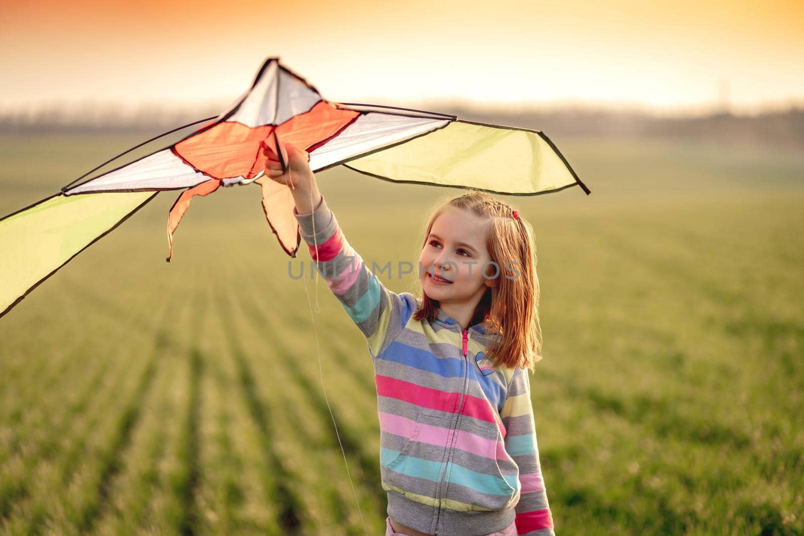 Little girl with flying kite by tan4ikk1