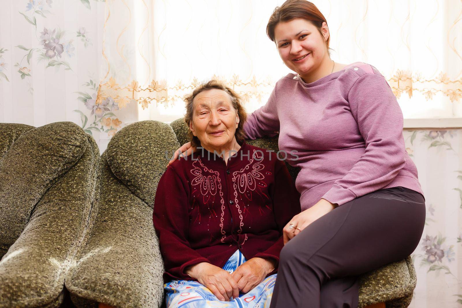 Grandmother and adult granddaughter embraced and happy