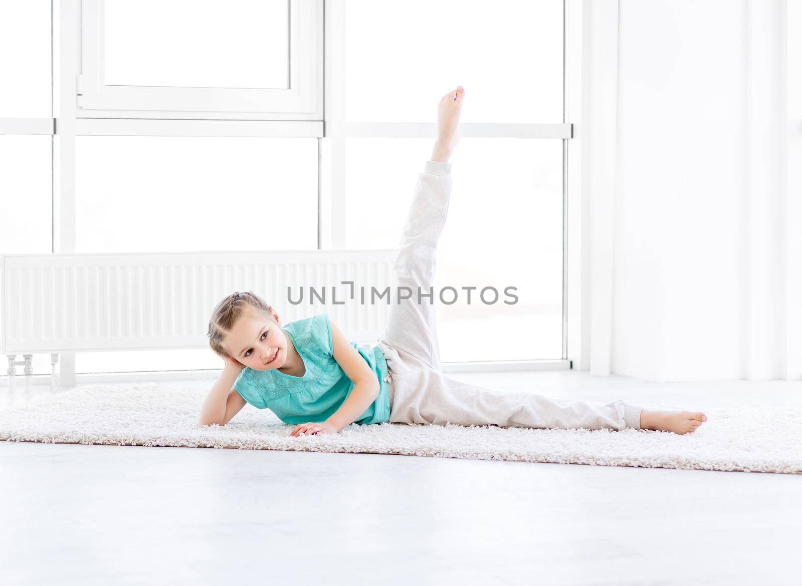 Cute little girl doing workout in gym