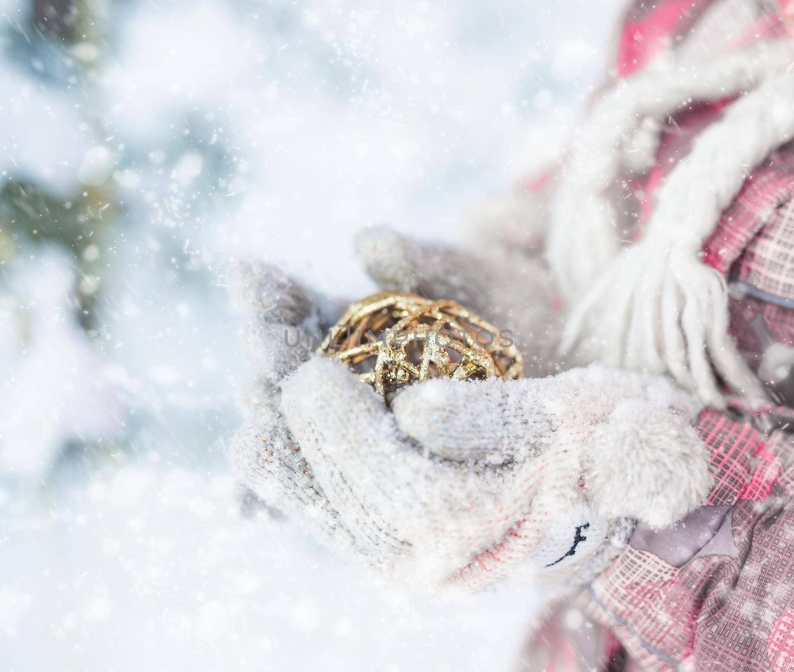 Closeup of little happy girl holding christmas tree decoration