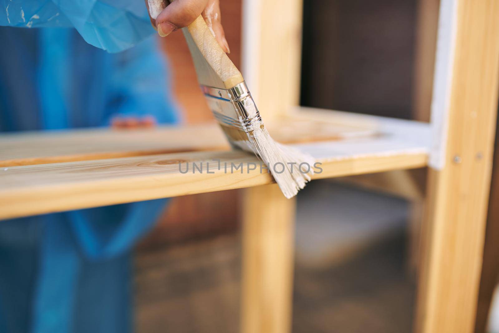 women paint wooden structures brush painter decoration. High quality photo