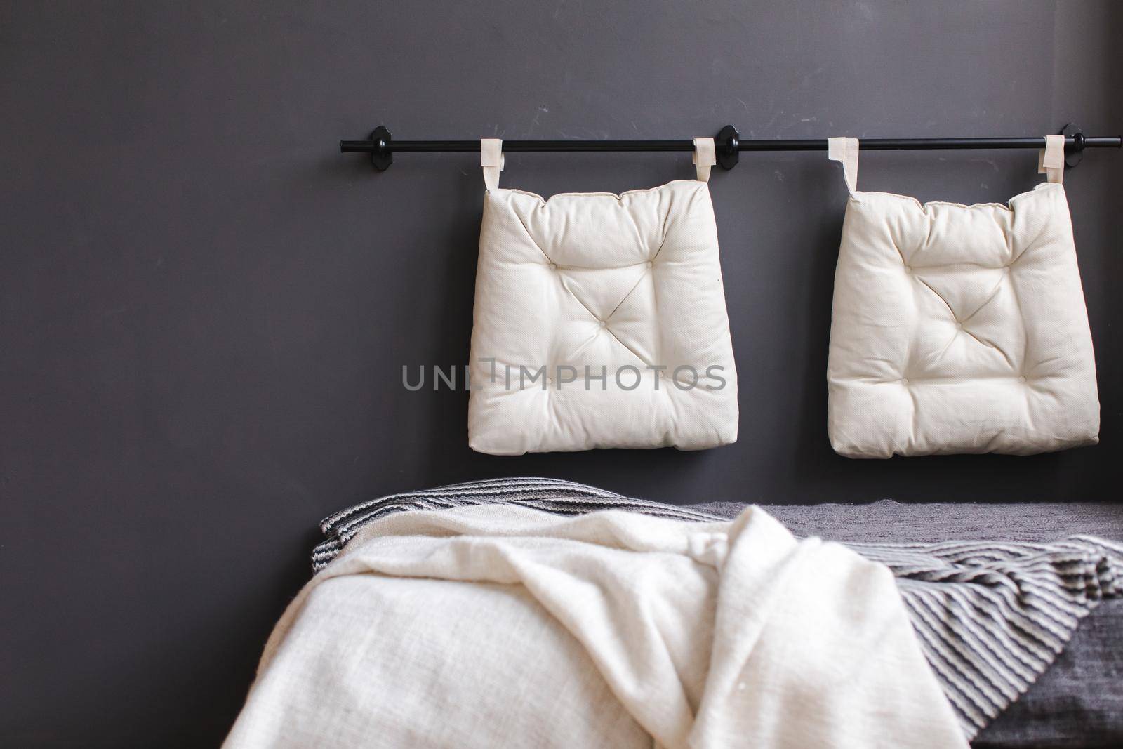 Small couch with cushions on wall by Demkat
